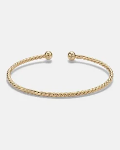Armreif Cablespira® Flex Micro aus 18kt Gelbgold mit Smaragden